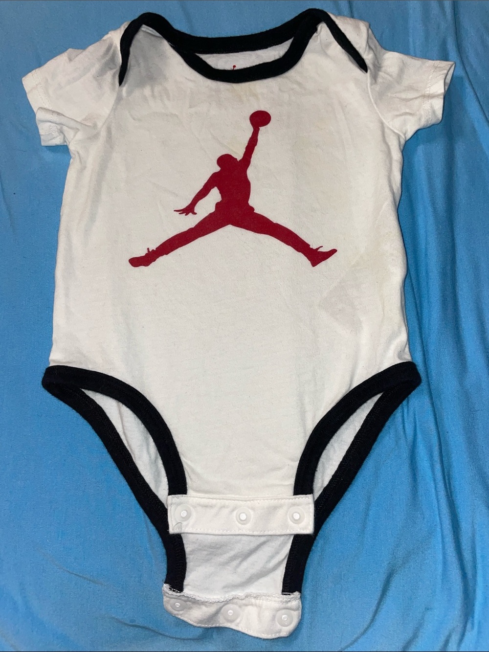 Jordan White Baby One-Piece with Black Trim and Red Jumpman